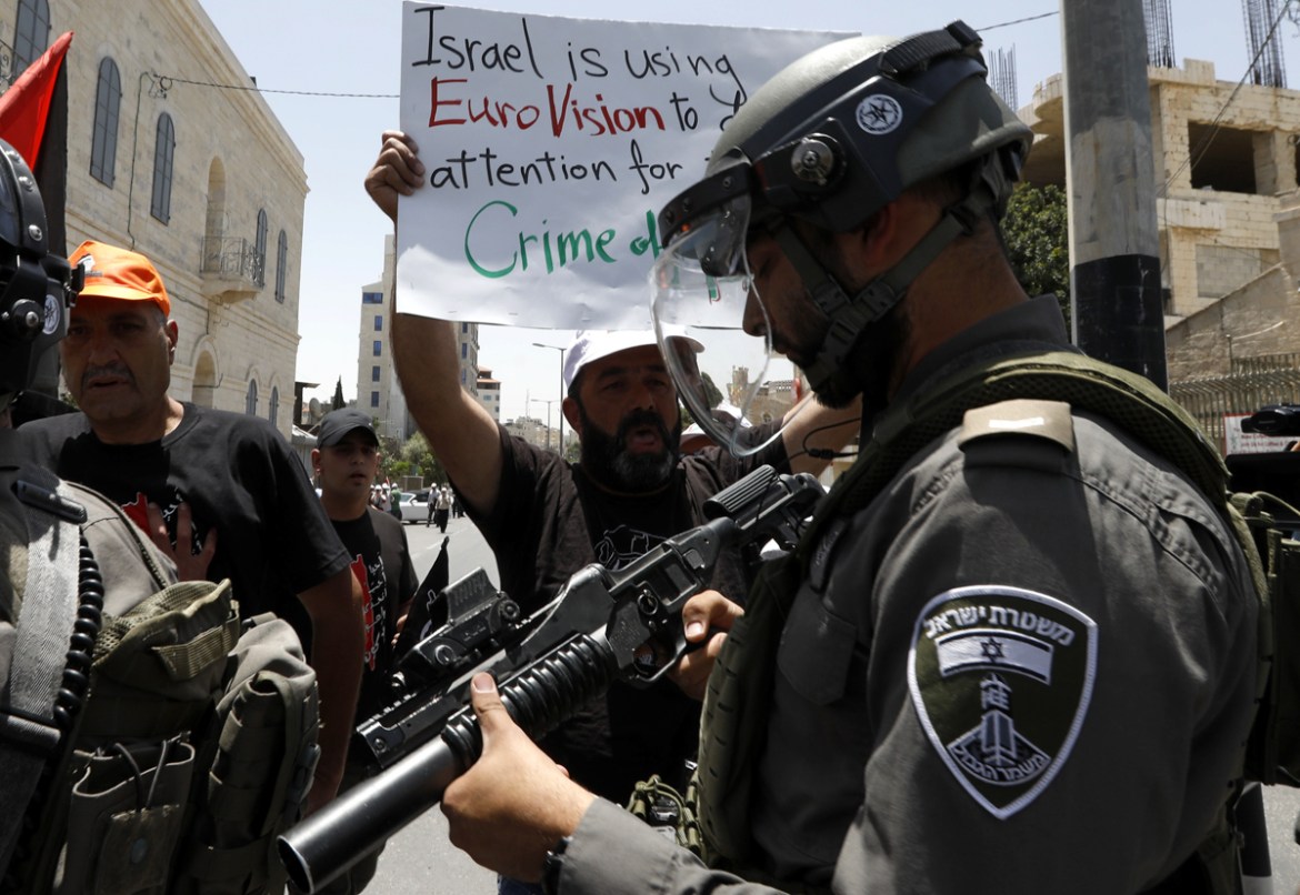 Palestinians hold placards and flags during a protest to mark the 71st anniversary of Nakba or catastrophe in the West Bank city of Bethlehem, 15 May 2019. Nakba Day, or Day of the Catastrophe, which