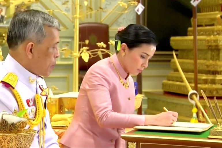 King Maha Vajiralongkorn and his consort, General Suthida Vajiralongkorn named Queen Suthida sign marriage documents during their wedding ceremony in Bangkok, Thailand May 1, 2019, in this screen grab