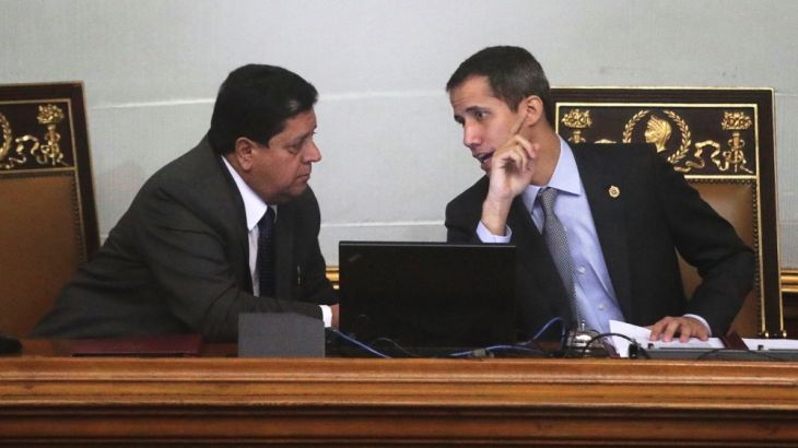Venezuelan opposition leader Juan Guaido, talks to Edgar Zambrano, the assembly vice president, in a session of the National A