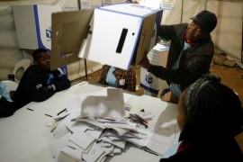 Election official empties a ballot box as counting begins after polls closed in Alexandra township in Johannesburg