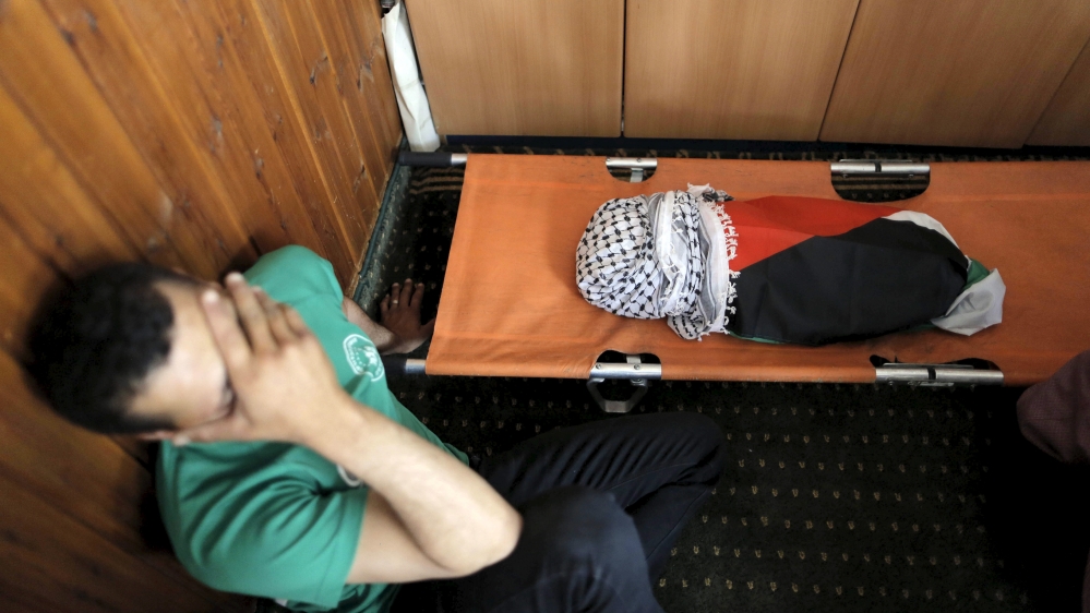 A mourner reacts next to the body of 18-month-old Palestinian baby Ali Dawabsheh, who was killed after his family's house in Duma village was set on fire in a suspected attack by Jewish settlers [File: Ammar Awad/Reuters]