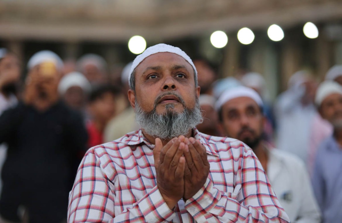 A Muslim man prays as he and others assemble to spot the crescent moon, on the eve of the holy fasting month of Ramadan at a mosque in Ahmedabad, India, May 6, 2019. REUTERS/Amit Dave
