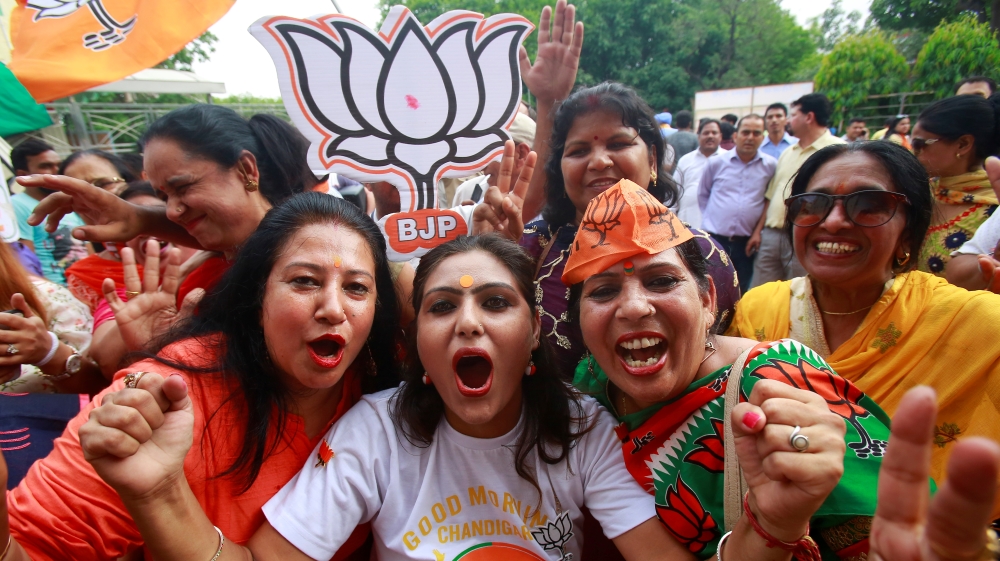 Supporters of Bharatiya Janata Party (BJP) celebrate after learning of initial poll results in Chandigarh