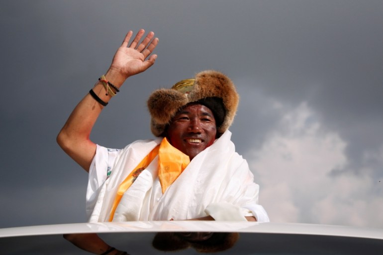Kami Rita Sherpa, 48, a Nepali Mountaineer waves towards the media personnel upon his arrival after climbing Mount Everest for a 22nd time, creating a new record for the most summits of the worldÕs hi