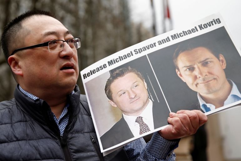 Louis Huang holds a placard ccalling for China to release Canadian detainees Michael Spavor and Michael Kovrig outside a court hearing for Huawei Technologies Chief Financial Officer Meng Wanzhou at t