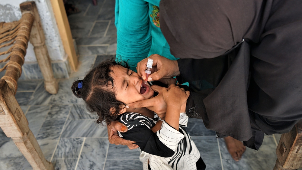 A child in Nowshera cries while receiving the polio vaccine [Sabrina Toppa/Al Jazeera]