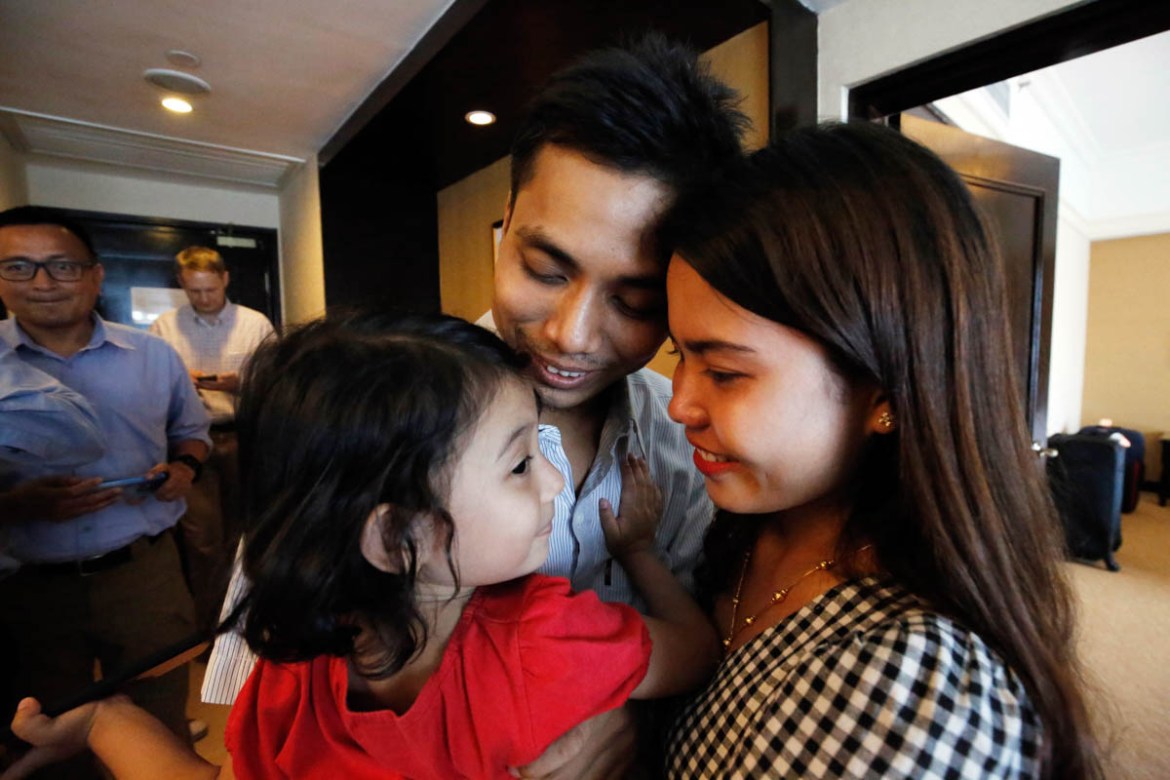 Reuters reporter Kyaw Soe Oo, center, holds his daughter with his wife Chit Su Win after being freed from prison, in Yangon, Myanmar, Tuesday, May 7, 2019. Two Reuters journalists who were imprisoned