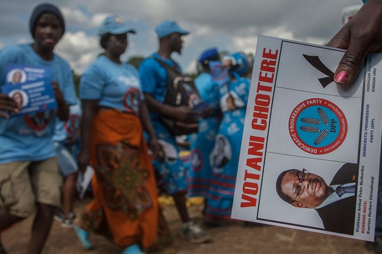 A supporter of Malawii´s ruling Democratic Party holds a dummy ballot paper urging people to vote for Malawian President Peter Mutharika during Mutharikai´s final election campaign rally at Mjamba Par