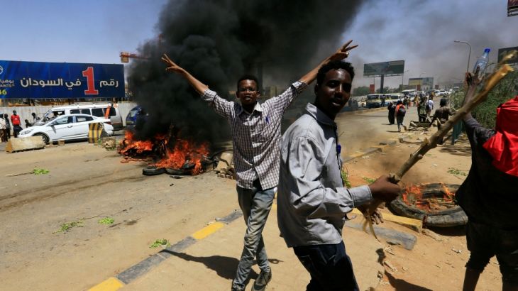 Sudanese protesters cheer as they burn tyres and barricade the road leading to al-Mek Nimir Bridge crossing over Blue Nile; that links Khartoum North and Khartoum, in Sudan May 13, 2019