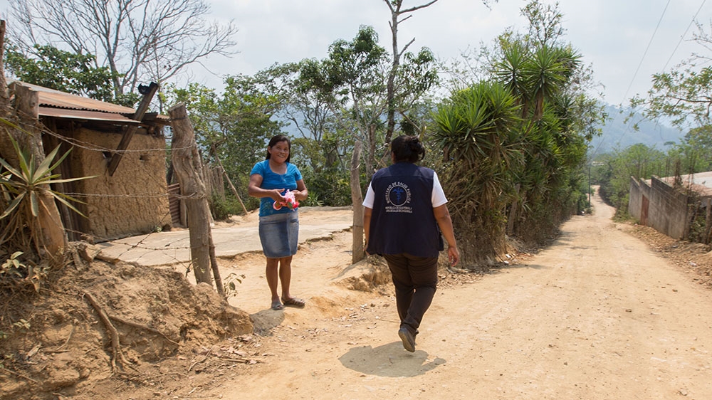 Gloria Amador walks through the village of Tizamarte [Jeff Abbott/Al Jazeera] 