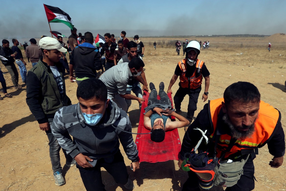 A wounded Palestinian boy is evacuated during a protest marking the 71st anniversary of the ''Nakba'', or catastrophe, when hundreds of thousands fled or were forced from their homes in the war surround