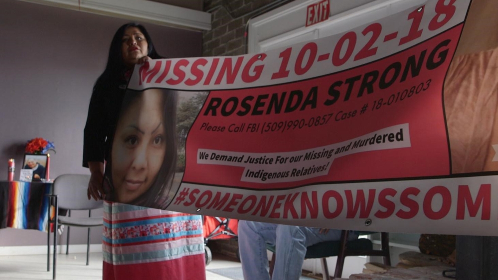 Roxanne White, a survivor and advocate, helps display a banner for Rosenda Strong, a mother-of-four who went missing in October of 2018 on the Yakama Nation [Al Jazeera]