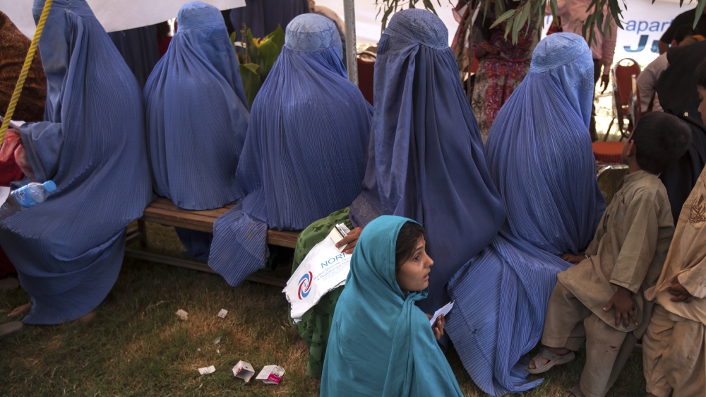 An Afghan refugee girl waits with others to have a medical check-up at a health clinic setup by the UNHCR to mark World Refugee Day in Islamabad June 20, 2014 [File: Faisal Mahmood/Reuters]