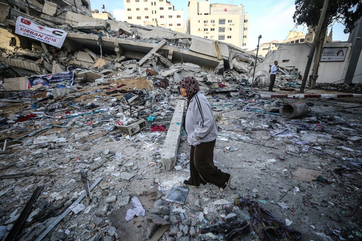A Palestinian woman inspects the totally destroyed Haznedar apartment after Israeli army carried out airstrikes after Er-Rimal neighborhood of Gaza City, Gaza on May 5, 2019. (Photo by Mustafa Hassona