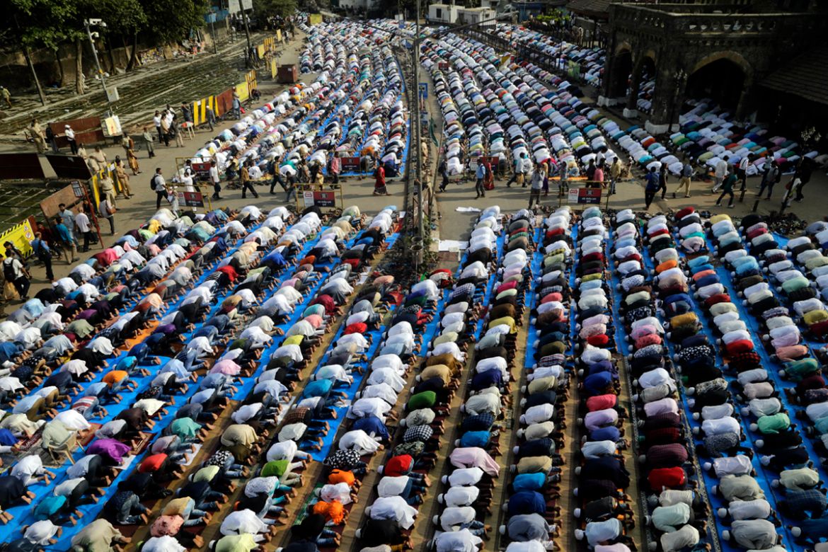 Muslims offer Eid al-Fitr prayers outside a train station in Mumbai, India, Wednesday, June 5, 2019. Eid al-Fitr is a holiday marking the end of the holy month of Ramadan, which is observed by million