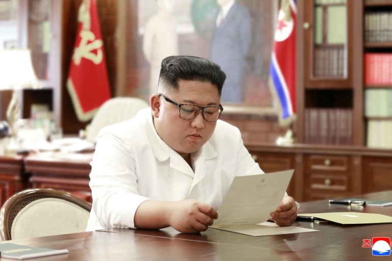 North Korean leader Kim Jong Un reads a letter from U.S. President Donald Trump, in Pyongyang