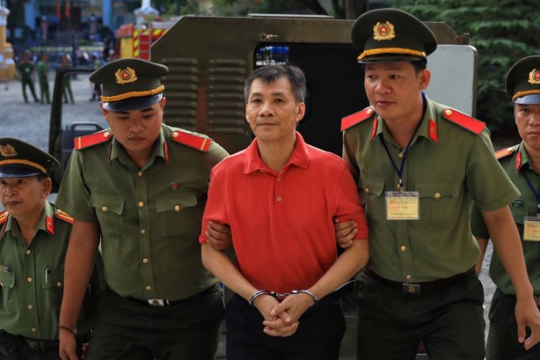 U.S. citizen Michael Nguyen is escorted by policemen before his trial at a court in Ho Chi Minh city, Vietnam June 24, 2019. REUTERS/Stringer NO RESALES. NO ARCHIVES. VIETNAM OUT