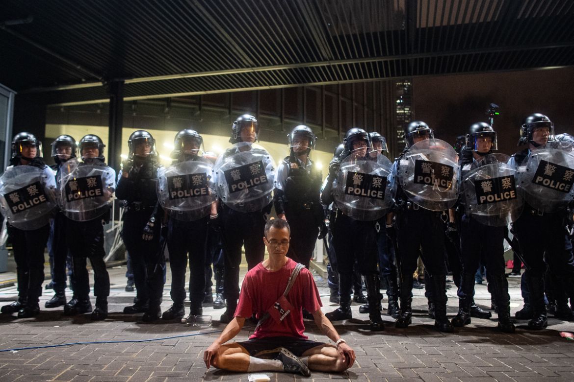 Police gather at a rally against a controversial extradition law proposal in Hong Kong on early June 10, 2019. - Hong Kong witnessed its largest street protest in at least 15 years on June 9 as crowds