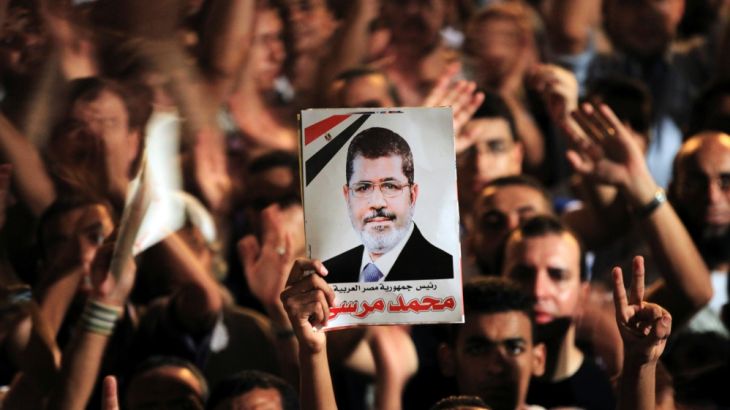 FILE PHOTO: A picture of Egypt''s first Islamist President Mohamed Mursi is held up as supporters cheer during a rally at Tahrir Square in Cairo