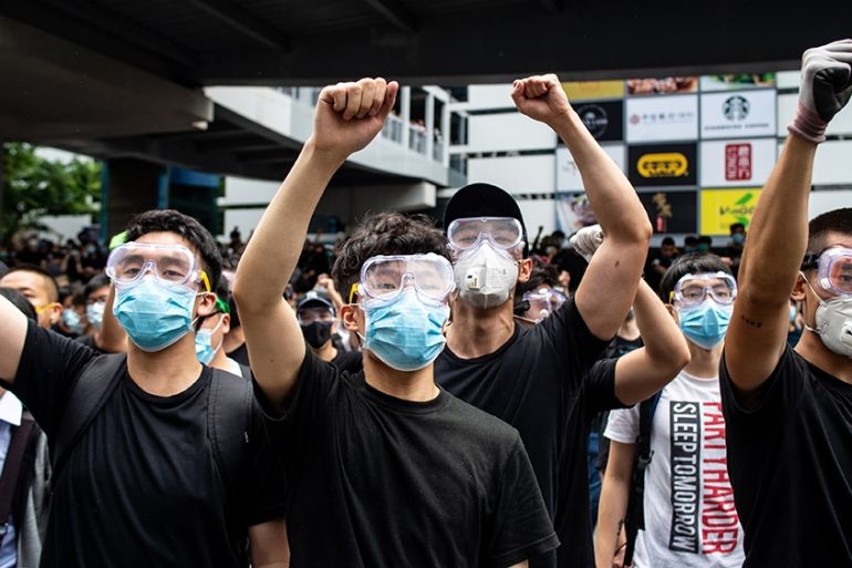 Protesters in masks and goggles chant slogans outside the Legislative Council in Hong Kong on June 12, 2019. - Hong Kong authorities delayed the second reading of a controversial bill allowing extradi