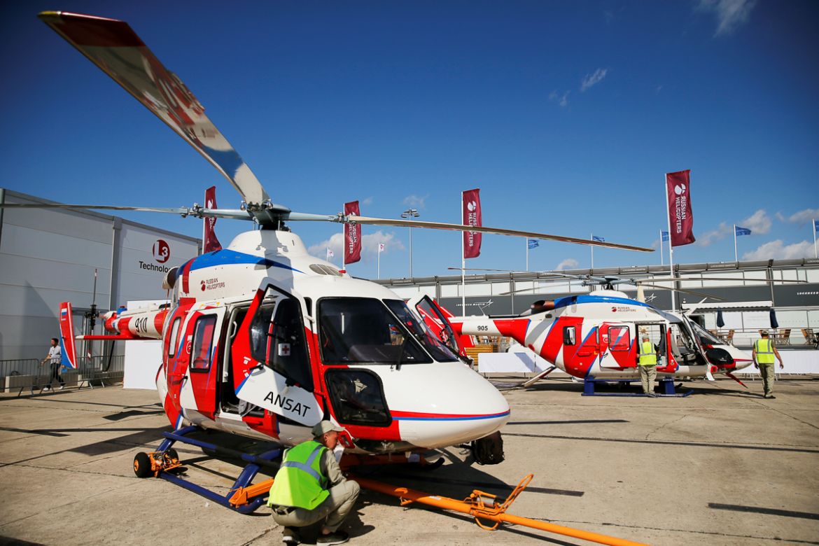 Technicians work on a Russian multi-purpose Ansat helicopters on the static display, before the opening of the 53rd International Paris Air Show at Le Bourget Airport near Paris, France, June 15 2019.