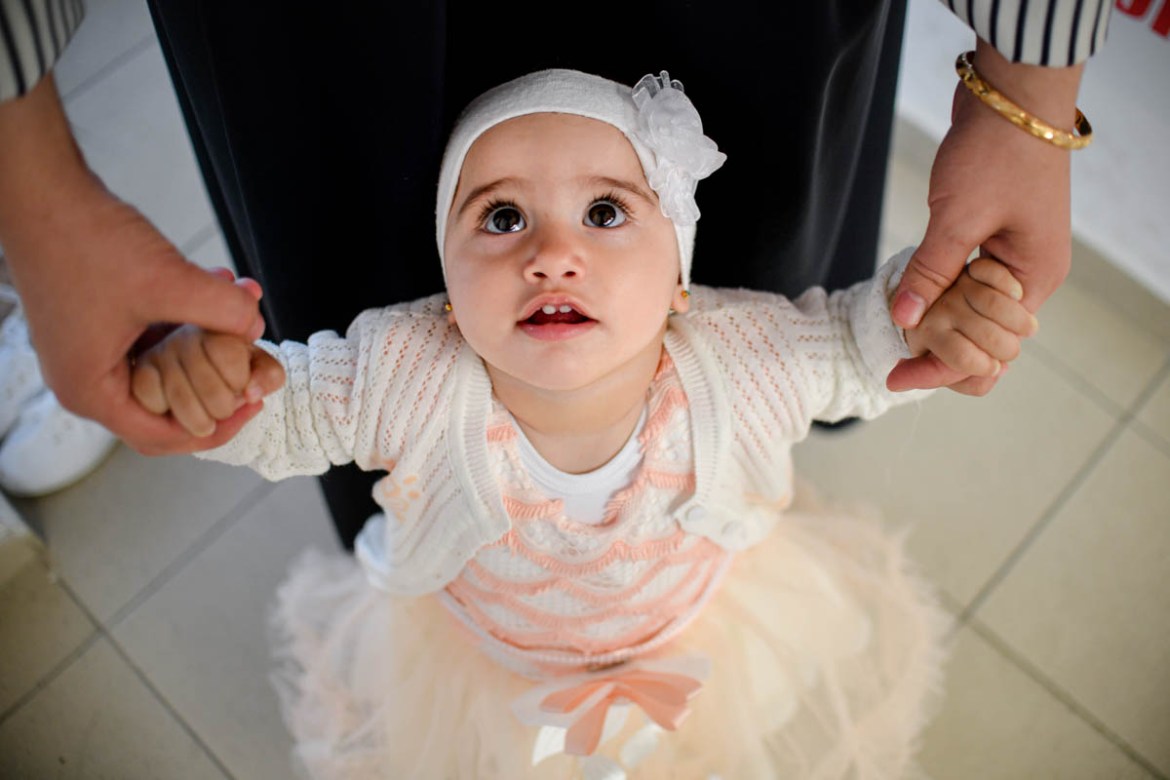 Amira, 10 months-old, holds her mother''s hands while waiting for the start of Eid al-Fitr prayers in Bucharest, Romania, Tuesday, June 4, 2019. Members of the Romanian Muslim community gathered for Ei