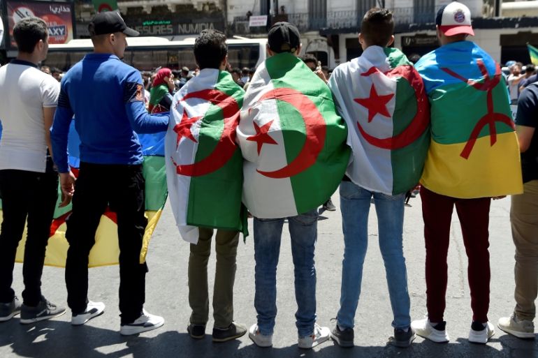 Students wear their national flag as they demonstrate in Algiers on June 11, 2019, two days after a vote planned for July 4 was cancelled. A vote planned for July 4 was cancelled on June 9 in the face