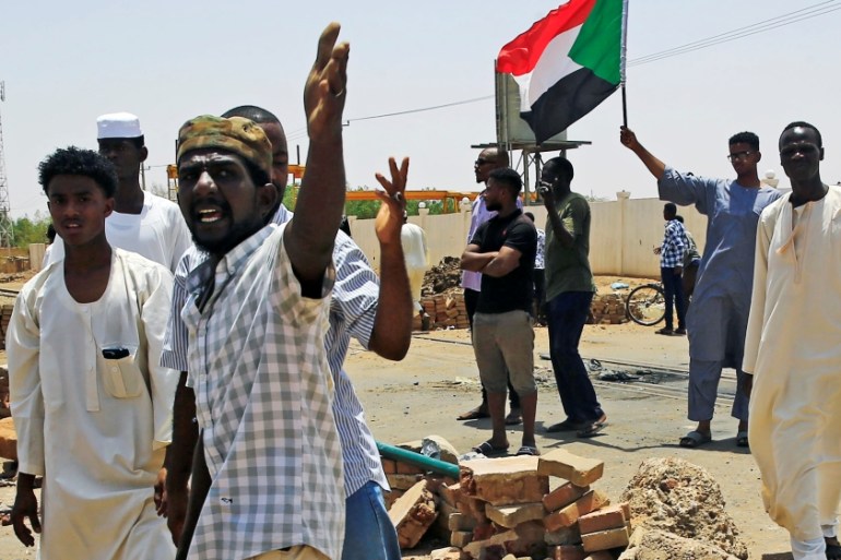 Sudanese protesters set up a barricade on a street, demanding that the country''s Transitional Military Council hand over power to civilians, in Khartoum
