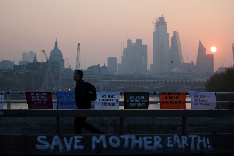 A commuter walks along Waterloo Bridge, which is being blocked by climate change activists, during the Extinction Rebellion protest in London, Britain April 17, 2019