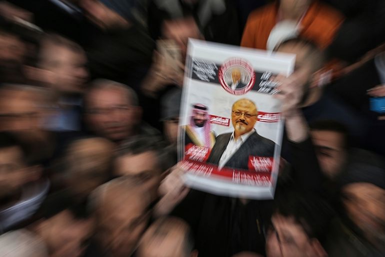 A person holds up a banner as members of the Arab-Turkish Media Association and friends attend funeral prayers in absentia for Saudi writer Jamal Khashoggi who was killed last month in the Saudi Arabi