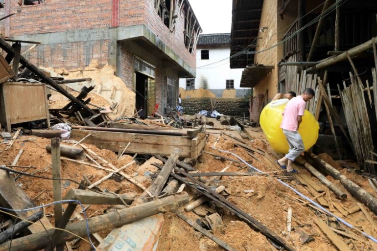 Villagers clean up their belongings after their houses were damaged by flood following heavy rainfall in Rongan county, Liuzhou, Guangxi Zhuang Autonomous Region, China June 10, 2019