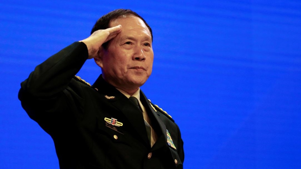 Chinese Defense Minister Wei Fenghe salutes at the IISS Shangri-la Dialogue in Singapore