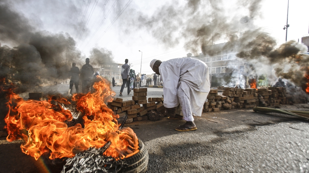 Sudanese protesters close Street 60 with burning tyres and pavers as military forces tried to disperse a sit-in outside Khartoum's army headquarters on June 3, 2019. At least two people were killed Mo