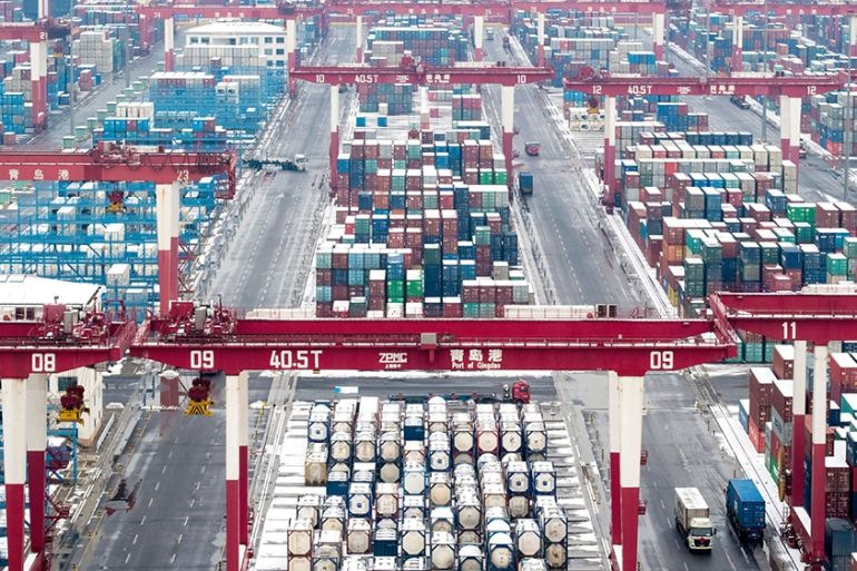 Shipping container and trucks at a port in China