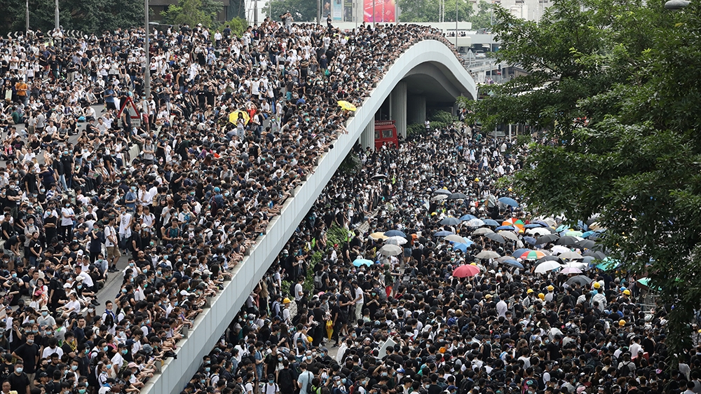Protesters march along a road demonstrating against a proposed extradition bill in Hong Kong, China June 12, 2019. REUTERS/Athit Perawongmetha -