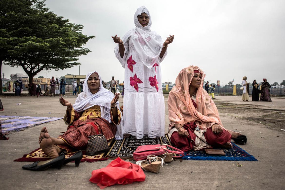 Muslim worshippers pray during a mass prayer to celebrate Eid al-Fitr on June 4, 2019 at the Stade des Martyrs in Kinshasa. Muslims worldwide celebrate the Eid al-Fitr holidays, which mark the end of