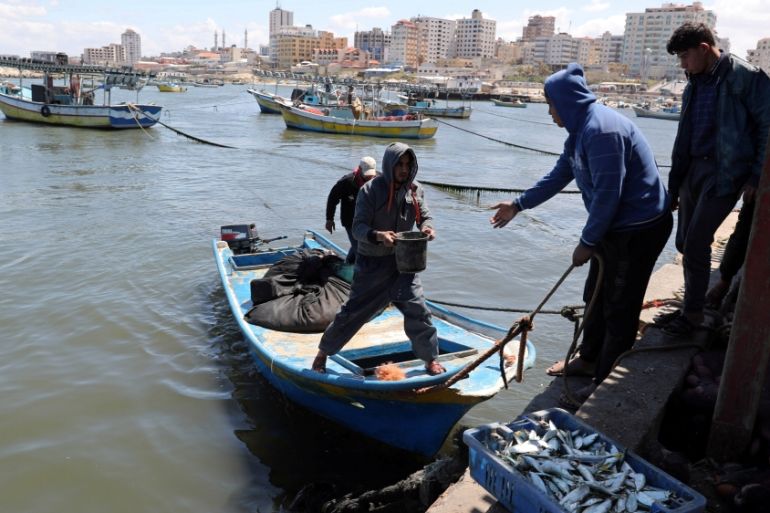 Palestinian fishermen unload their catch at the seaport of Gaza City