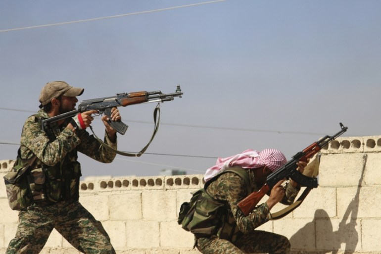 n this Oct. 11, 2015 file photo, Syrian soldiers fire repelling an attack in Achan, Hama province, Syria