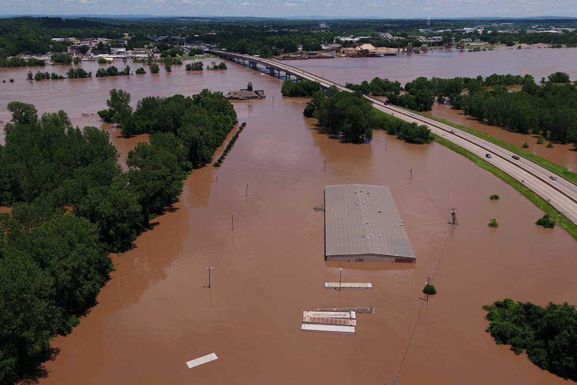 The consequences of building in a flood plain. A building sits submerged in the flood waters of the Arkansas River in this aerial photo in Fort Smith, Arkansas, U.S., May 30, 2019.