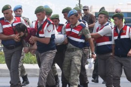 Haldun Gulmez, a soldier accused of attempting to assassinate Turkish President Erdogan on the night of the attempted coup, is carried by gendarmes as he arrives at the court in Mugla