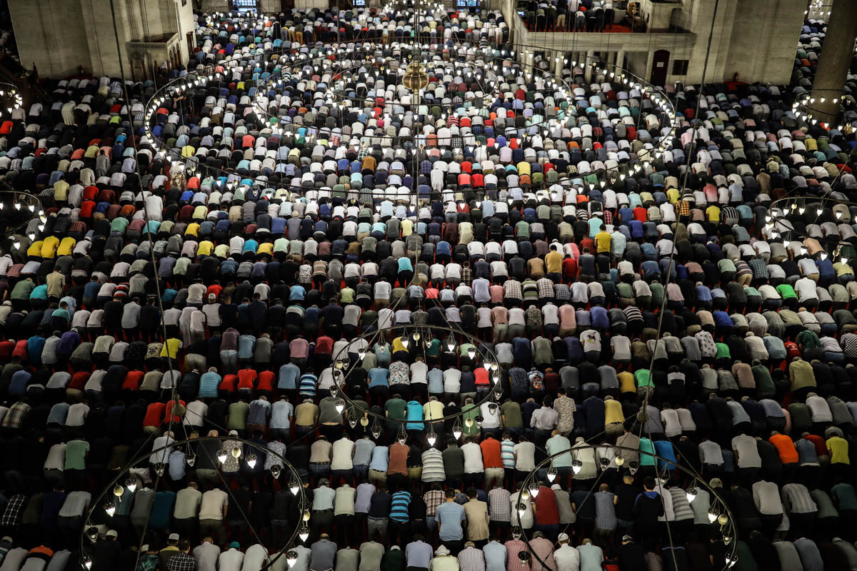 Turkey's Muslims offer prayers during the first day of Eid al-Fitr, which marks the end of the holy fasting month of Ramadan at the Suleymaniye Mosque in Istanbul, early Tuesday, June 4, 29. (AP Photo