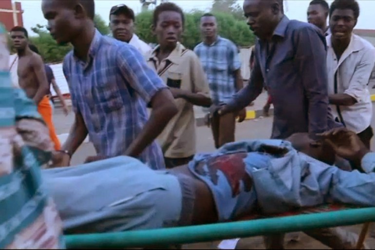 An image grab taken from a video posted on Ahmed Kwarte''s Facebook page shows Sudanese protesters carrying a wounded demonstrator during confrontation with security forces near Khartoum''s army headq