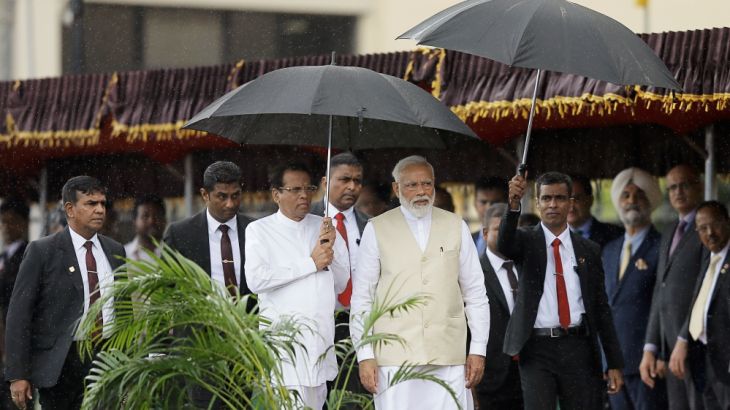 India''s Prime Minister Narendra Modi arrives with Sri Lanka''s President Maithripala Sirisena during his welcome ceremony at the Presidential Secretariat in Colombo