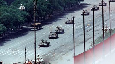 FILE PHOTO 5JUN89 - A Peking citizen stands passively in front of tanks on the Avenue of Eternal Peace in this June 5, 1989, file photo taken during the crushing of the Tiananmen Square uprising. The 