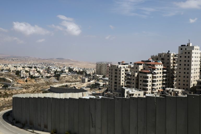 General view picture shows the Israeli barrier running between the East Jerusalem refugee camp of Shuafat and Pisgat Zeev
