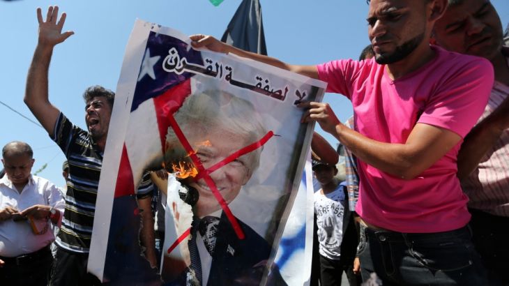 Palestinian demonstrators burn a crossed-out poster depicting U.S. President Donald Trump during a protest against Bahrain''s workshop for U.S. Middle East peace plan, in the southern Gaza Strip