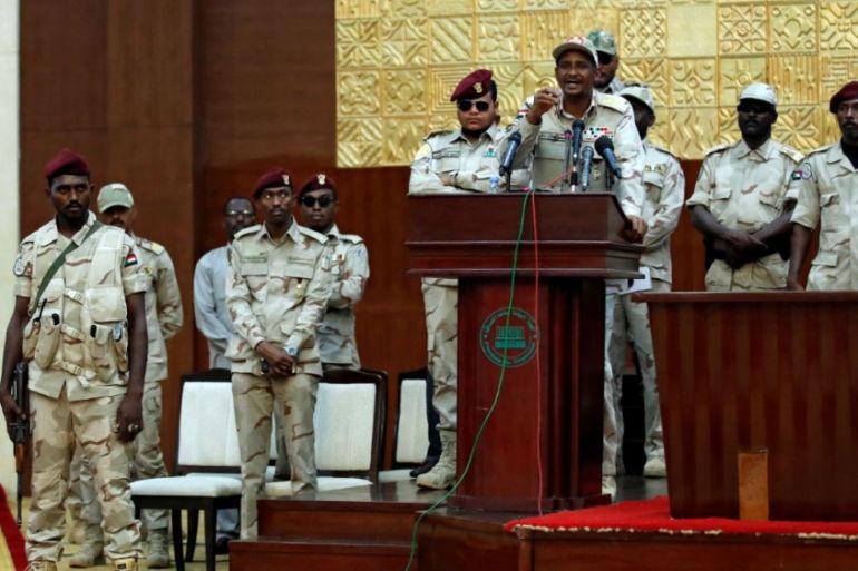 Lieutenant General Mohamed Hamdan Dagalo addresses his supporters while being surrounded by his security guards during a meeting in Khartoum