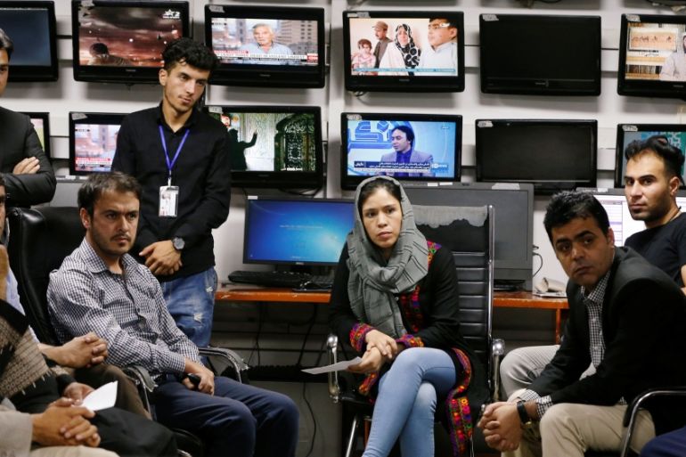 Afghan journalists attend a meeting in the Tolo newsroom, in Kabul, Afghanistan