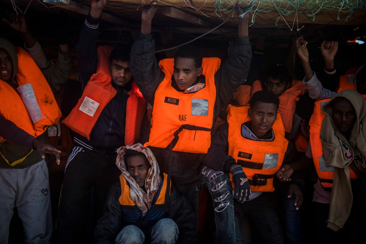In this Saturday Jan. 27, 2018 photo, 329 refugees and migrants, mostly from Eritrea and Bangladesh, wait to be rescued by aid workers after leaving Libya trying to reach European soil aboard an overc