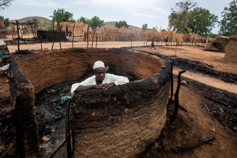 A man is seen inside a burnt house during clashes between nomads and residents in Deleij village, located in Wadi Salih locality, Central Darfur, Sudan June 11, 2019. Picture taken June 11, 2019. REUT